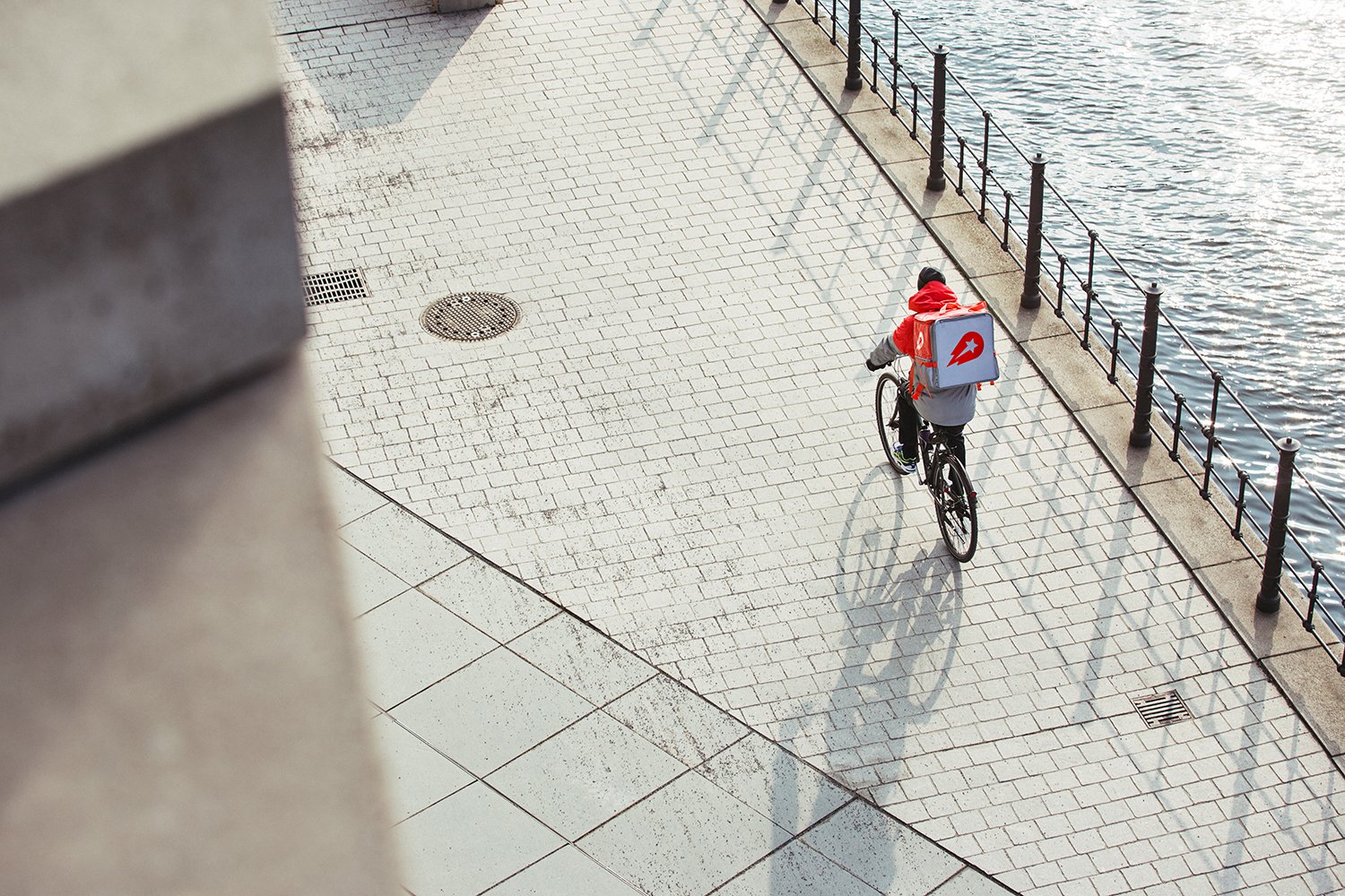 Delivery worker on a bicycle.